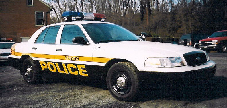 White Easton Police Crown Victoria with yellow stripe and lettering, front three-quarter