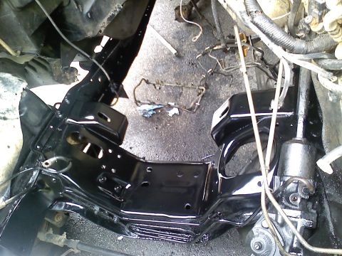1990 Ford Bronco - Close-up view of a vehicle's engine bay frame, showing exposed components and wiring.