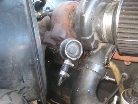 1976 Ford F-250 - Engine bay detail showing a turbocharger and associated plumbing.