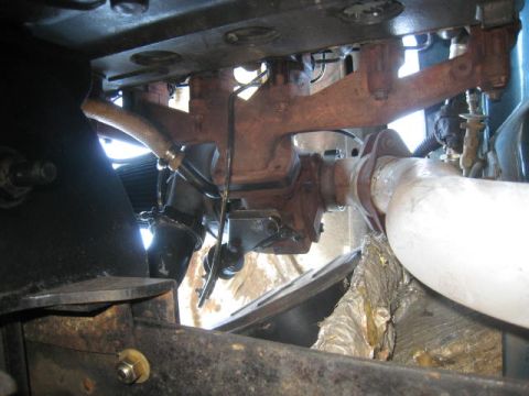 1976 Ford F-250 - View of the exhaust system components, including the manifold and pipe, under a vehicle.