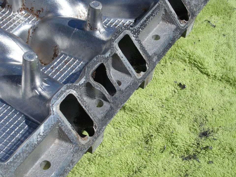 Aluminum intake manifold with multiple ports, resting on a green towel