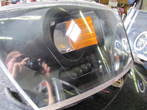 2005 Dodge 3500 - Headlight assembly shown in detail, with a reflection of the photographer in the lens.
