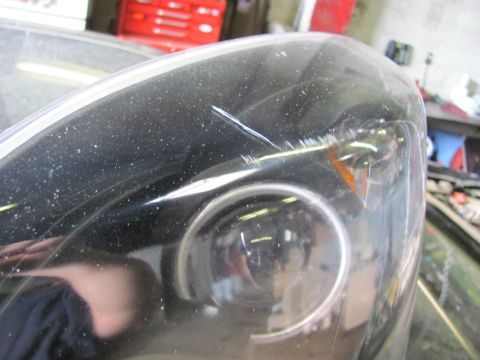 2005 Dodge 3500 - Headlight assembly shows a scratch on the clear lens.