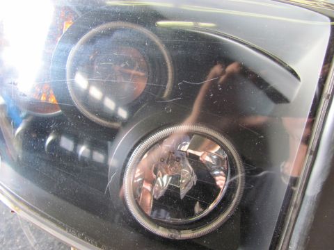 2005 Dodge 3500 - This headlight assembly shows significant scratching on its clear plastic cover.