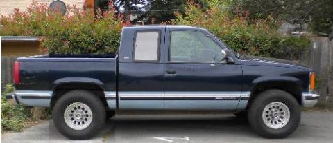 1989 Ford Bronco - This pickup truck has a two-tone paint scheme with a prominent side stripe.