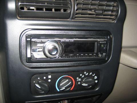 2005 Jeep Wrangler - Close-up of a car's dashboard showing the stereo system and climate control knobs.