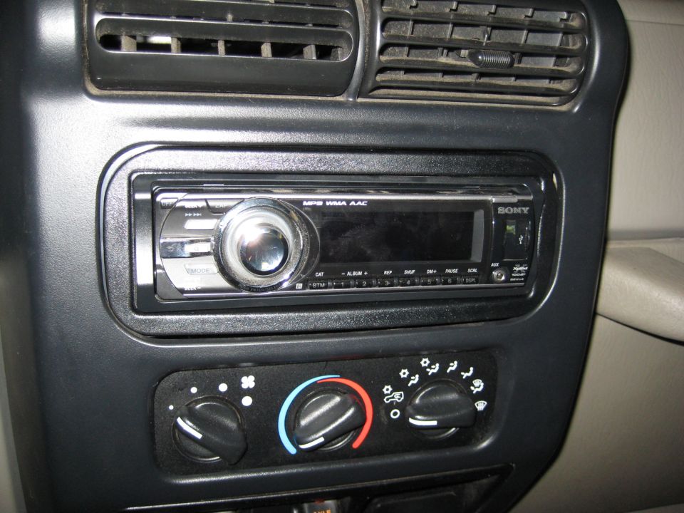 Car stereo and climate control knobs with air vents above. The stereo is a Sony unit