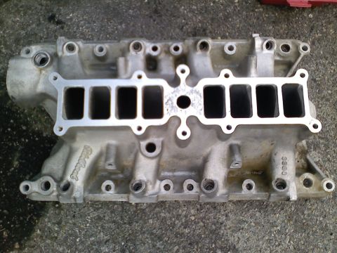 1990 Ford Bronco - An Edelbrock intake manifold is shown, visible casting numbers and ports for engine cylinders.