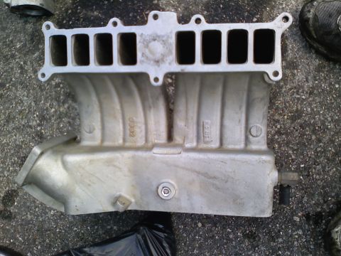 1990 Ford Bronco - Aluminum intake manifold with six intake ports and visible part number 3302.