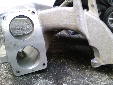 1990 Ford Bronco - This is a close-up view of an intake manifold, a component of a vehicle's engine.