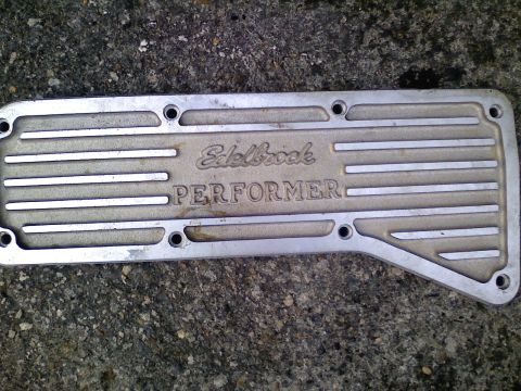 1990 Ford Bronco - An Edelbrock Performer valve cover is shown against a textured background.
