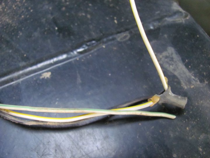 close-up of vehicle wiring harness with yellow, green, and white wires