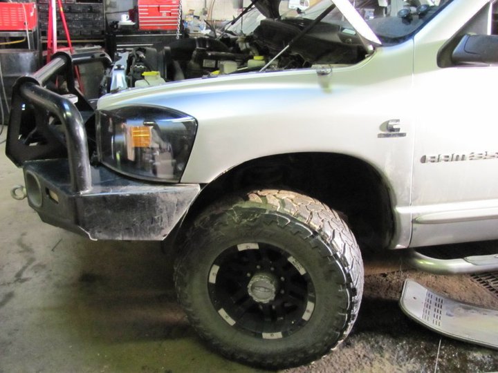 Silver pickup truck with aftermarket bumper and hood open. "Cummins" and "2500" visible on the fender