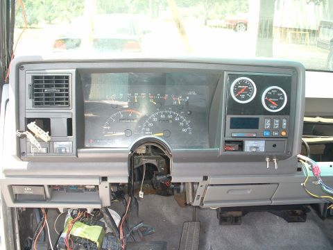 1994 GMC Suburban - The interior dashboard of a 1995 GMC Suburban shows exposed wiring and aftermarket gauges.