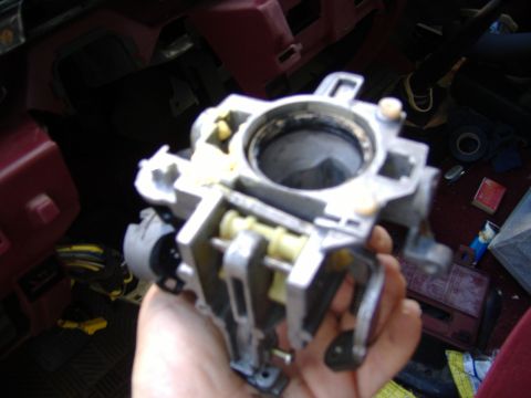 1995 Ford F-150 - Disassembled steering column ignition switch housing, likely from an older vehicle.