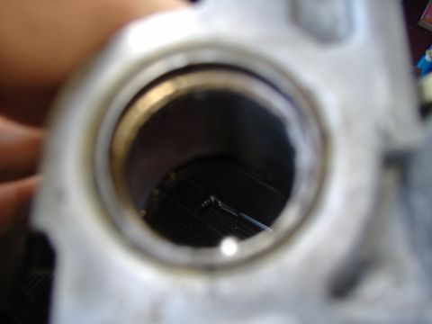 1995 Ford F-150 - A metal steering column part is shown with a black grate visible within its opening.