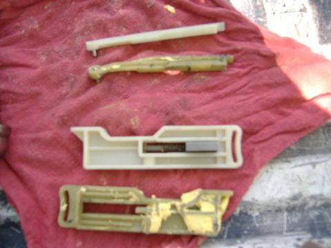 1995 Ford F-150 - Various plastic and metal parts from a disassembled steering column are laid out on a red cloth.