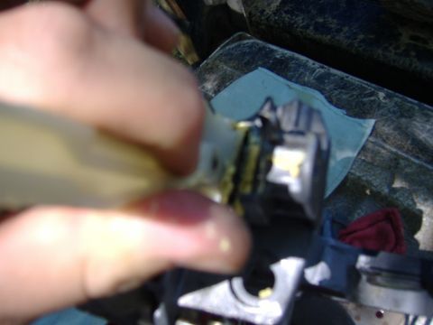 1995 Ford F-150 - A hand is shown working on a steering column component, applying grease to a part.