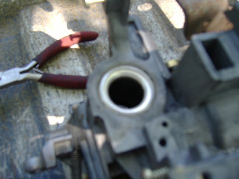 1995 Ford F-150 - A close-up view of a mechanical part, likely from a vehicle's steering column, with a pair of pliers nearby.