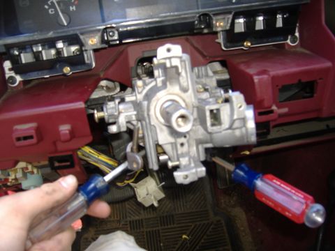 1995 Ford F-150 - Steering column assembly with ignition cylinder and keys, viewed from interior. Tools are present, suggesting repair or maintenance.