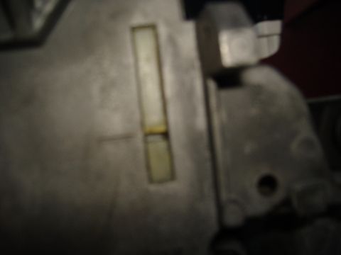 1995 Ford F-150 - This image shows a close-up of a metal component, possibly from a steering column, with a visible rectangular window.