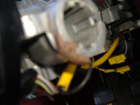 1995 Ford F-150 - Close-up view of the steering column wiring harness, showing yellow connectors and black protective loom.