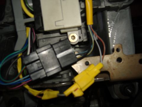 1995 Ford F-150 - The intricate wiring and connectors within a vehicle's steering column are visible in this close-up shot.