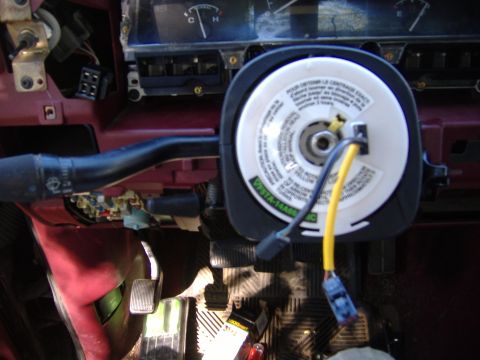1995 Ford F-150 - Close-up of a steering column, showing the airbag clock spring and associated wiring. The part number VISTA-14A66 is visible.