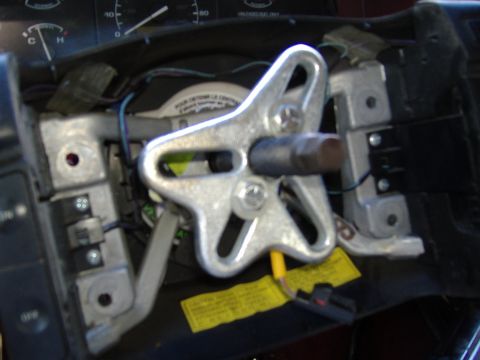 1995 Ford F-150 - The internal components of a vehicle's steering column are visible, including wiring and metal brackets.