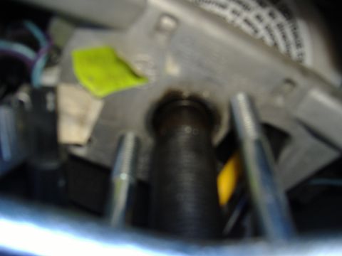 1995 Ford F-150 - Close-up view of internal steering column components, including wiring and mounting hardware.