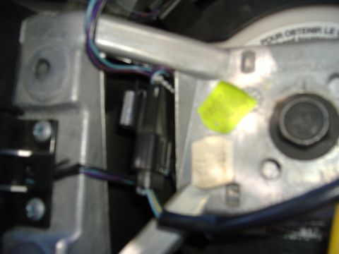 1995 Ford F-150 - Close-up view of electrical connectors and wiring within a vehicle's steering column.