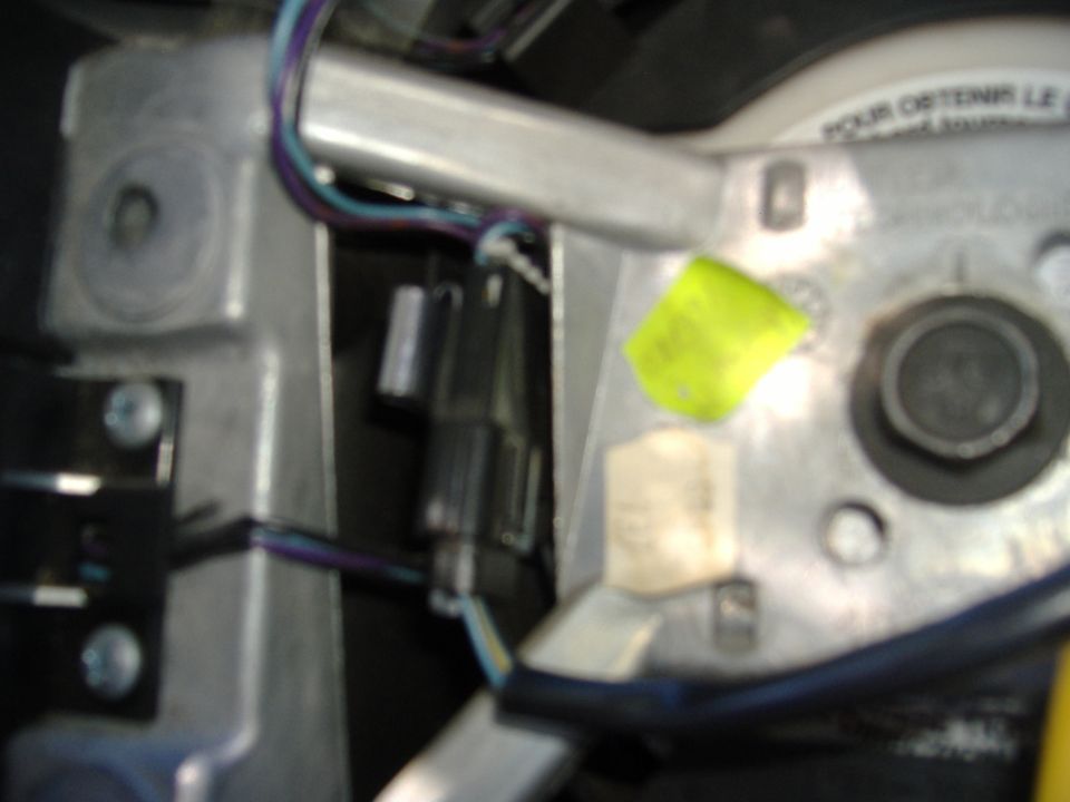 Steering column assembly with wires, connectors, and yellow sticker
