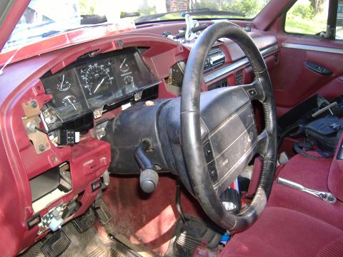 1995 Ford F-150 - The interior of a 1995 Ford F-150, focusing on the steering column and the partially disassembled dashboard.