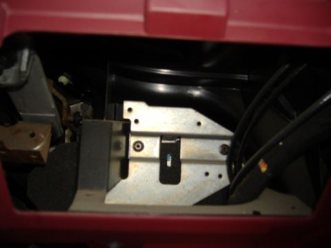 1995 Ford F-150 - Close-up of a metal bracket and ducting assembly within a vehicle's dashboard.