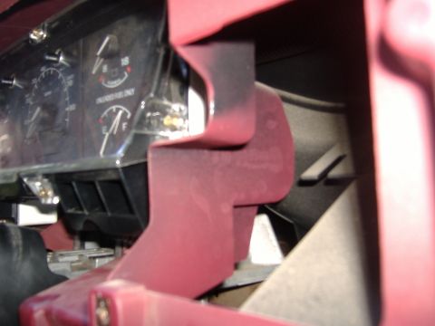 1995 Ford F-150 - Interior view of a red steering column and dashboard gauges, likely from a 1995 Ford F-150.