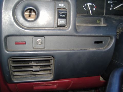 1995 Ford F-150 - Interior view of a vehicle's dashboard, showing various controls and a gauge.