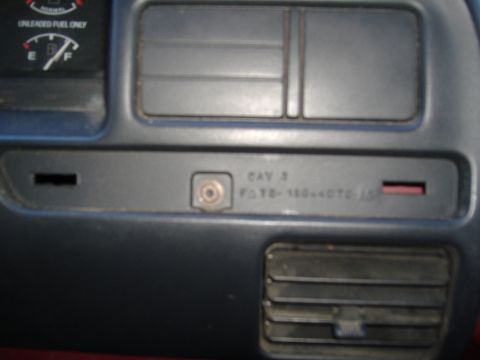 1995 Ford F-150 - Close-up of a vehicle's interior dashboard, showing a fuel gauge and a part identification number.