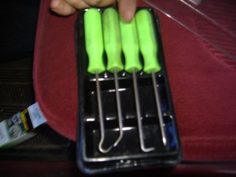 1995 Ford F-150 - A set of four hook and pick tools with green handles is held in a black plastic case.
