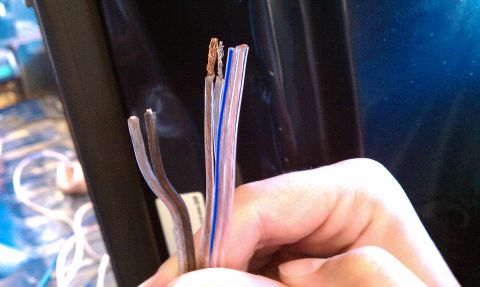 1992 Ford Bronco - Close-up of frayed electrical wires, possibly for audio system installation.