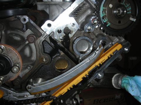 1992 Ford Crown Victoria - Close-up view of an engine's timing chain, tensioner, and gears, likely during a rebuild or repair.