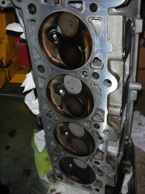 1992 Ford Crown Victoria - Close-up of an engine cylinder head, revealing internal components and signs of wear.