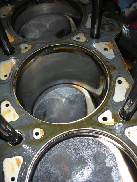 1992 Ford Crown Victoria - Close-up view of engine cylinders, likely from a rebuild project, showing internal wear and oil staining.