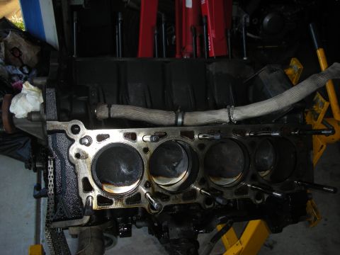 1992 Ford Crown Victoria - Engine block with pistons visible, mounted on a yellow engine stand.