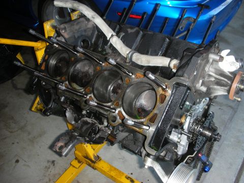 1992 Ford Crown Victoria - Engine block on a stand, undergoing rebuild or repair. Timing components are visible.