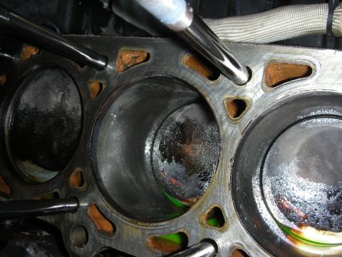 1992 Ford Crown Victoria - Engine cylinder block showing wear and liquid pooling within the cylinders.