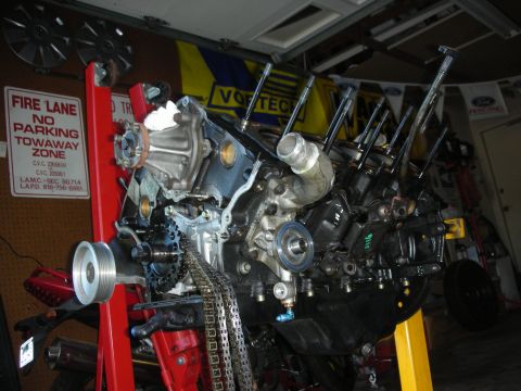 1992 Ford Crown Victoria - Engine assembly on a stand in a garage setting, showing internal components and external hardware.