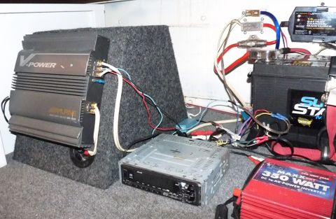 2006 Ford E350 - A collection of car audio components including amplifiers, a subwoofer, a stereo, and a power inverter are visible.