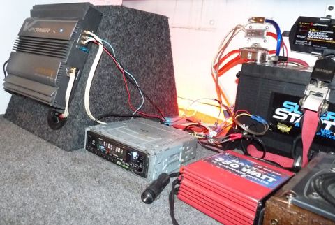 2006 Ford E350 - A car's audio system is shown, a V-Power amplifier, a 350-watt inverter, a battery, and a car stereo.