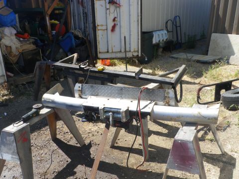 1991 Ford Bronco - Custom winch bumper assembly is being worked on outdoors.