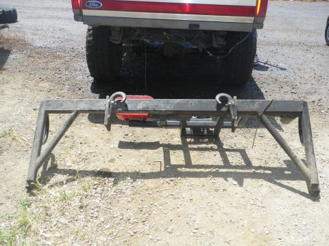 1991 Ford Bronco - The rear of a Ford truck, likely a 1992 model, is shown with a heavy-duty metal rack positioned before it.
